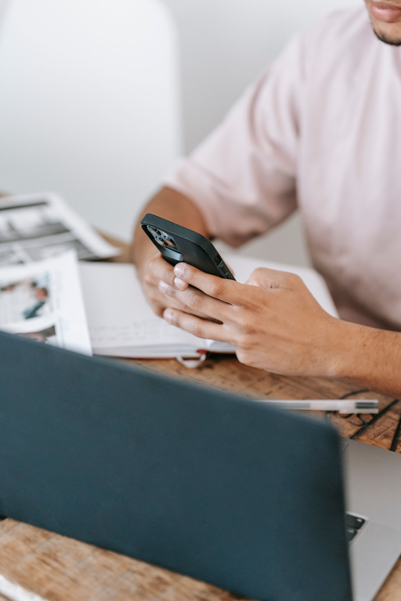 A person at a desk checking a payment on a phone